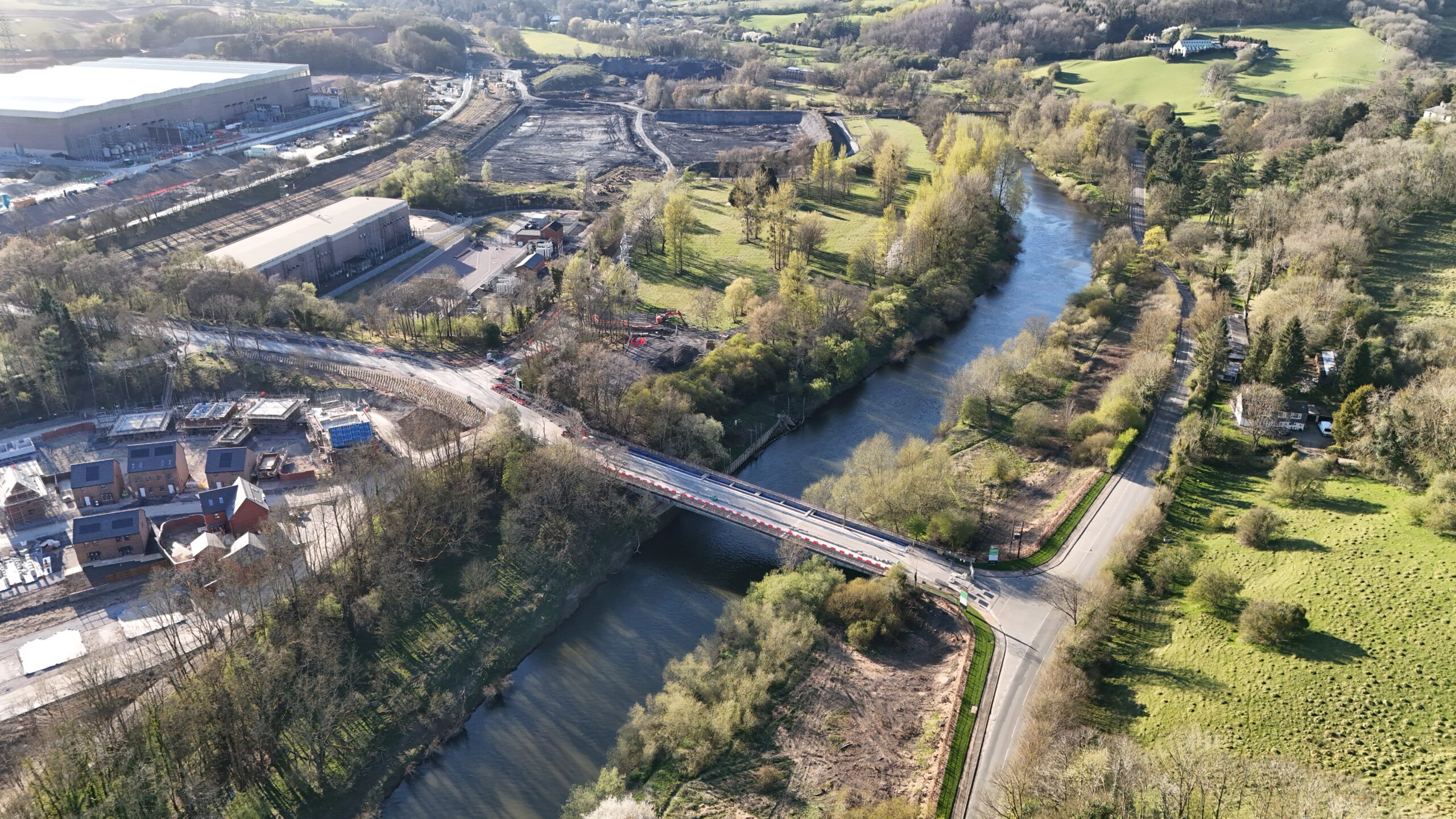 Benthall Grange development from the old Ironbridge site. This shows the site from the air with a bridge over a river . it is described as Phase 1B public open space and river bridge