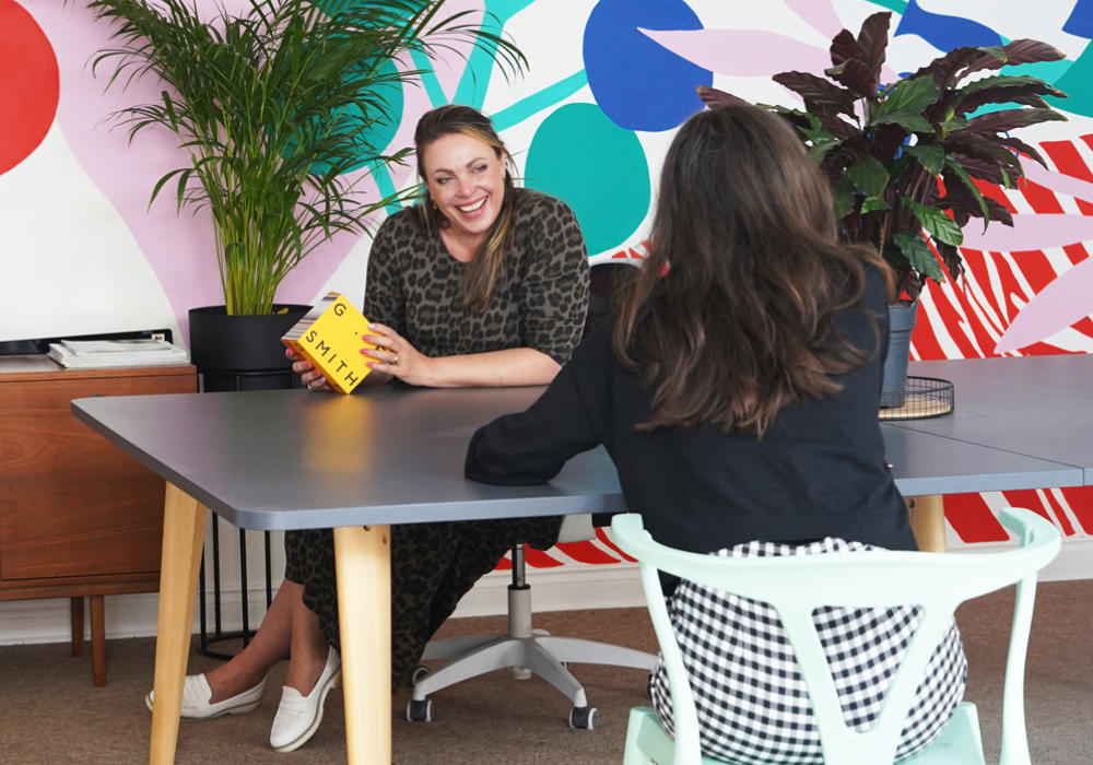 Two people at a brightly coloured startup office