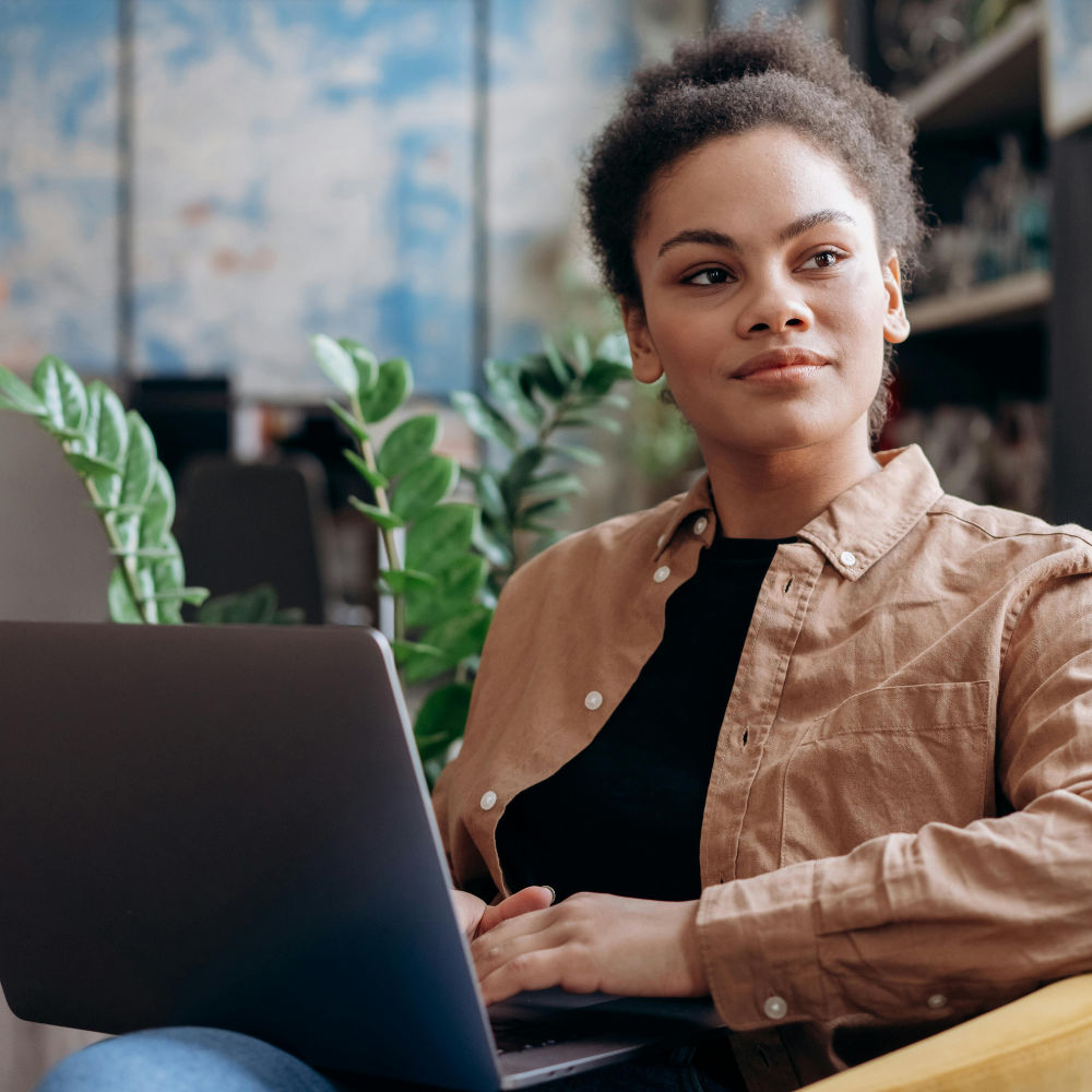 A female business founder working at a laptop