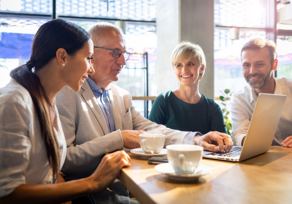 Four business people at a business support meeting