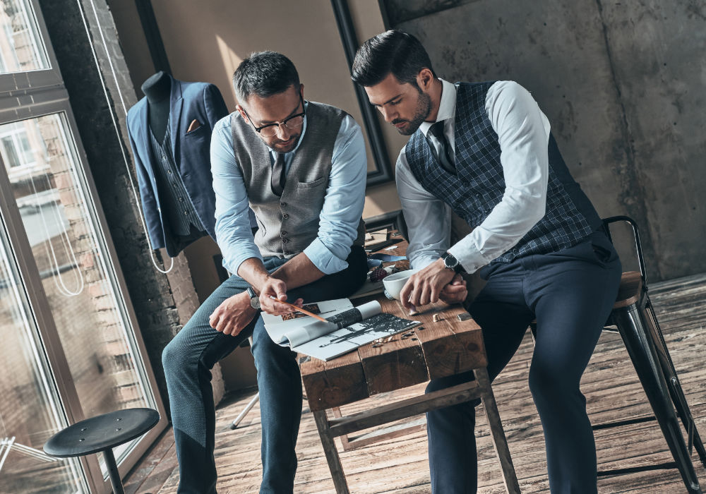 Two business founders browse through a catalogue